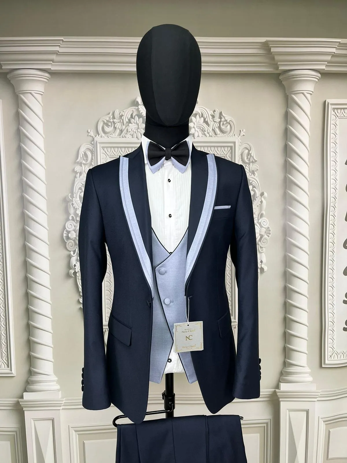 Single Button Three Pieces Tuxedo Suit with contrasting green velvet Lapel, matching bow tie and Black Pants.